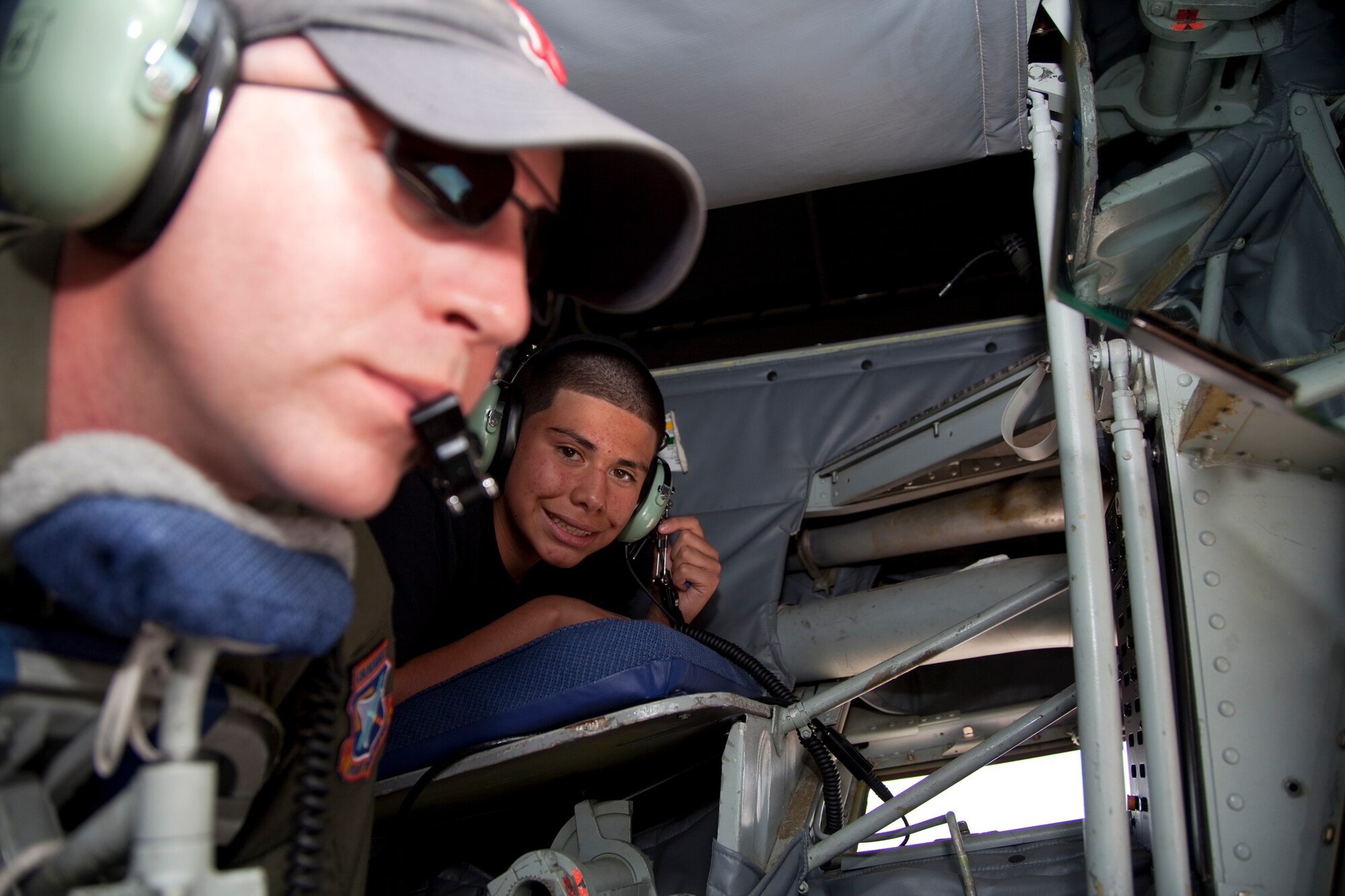 Master Sgt. Thomas Ireland, 445th Flight Test Squadron superintendent and boom operator, operates the boom on a KC-135 while Civil Air Patrol Airman 1st Class Francisco Gonzales watches.  CAP cadets got the chance to watch the mid-air refueling of a B-2 stealth bomber June 7.  (U.S. Air Force photo by Bobbi Zapka)