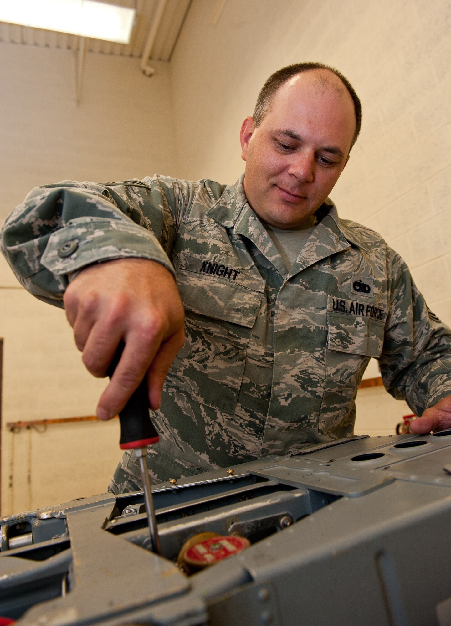 Tech. Sgt. Robert Knight, 28th Maintenance Squadron aircrew egress system technician, evaluates an environmental sensor during a quality check on a training Advanced Concept Ejection Seat II in the egress shop on Ellsworth Air Force Base, S.D., June 12, 2012. The environmental sensor is responsible for communicating with the computer systems in the aircraft to ensure that Airmen can eject properly and safely if required to do so. There are four ACES II systems installed in every B-1 bomber. (U.S. Air Force photo by Airman 1st Class Kate Thornton/Released)