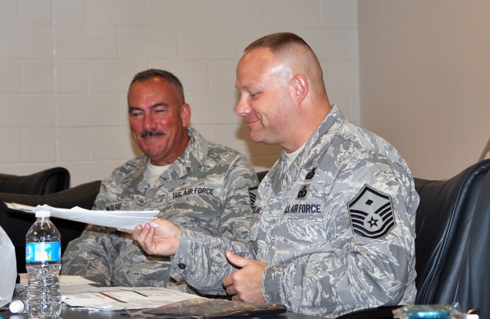 Master Sgt. Steven D. Winters, 94th Force Support Squadron first sergeant, and Master Sgt. David F. Strickland, 94th Security Forces Squadron first sergeant, share a laugh at the 94th Airlift Wing first sergeant’s council meeting on June 1, prior to the Dobbins Air Reserve Base unit training assembly. Winters serves as the president of the council and Strickland serves as the vice president. They lead discussions on topics concerning 94th Airlift Wing Airmen including the Single Airmen’s Initiative, Dobbins First Four and encouraging Airmen to check thier credit reports. (U.S. Air Force photo/Senior Airman Elizabeth Gaston)