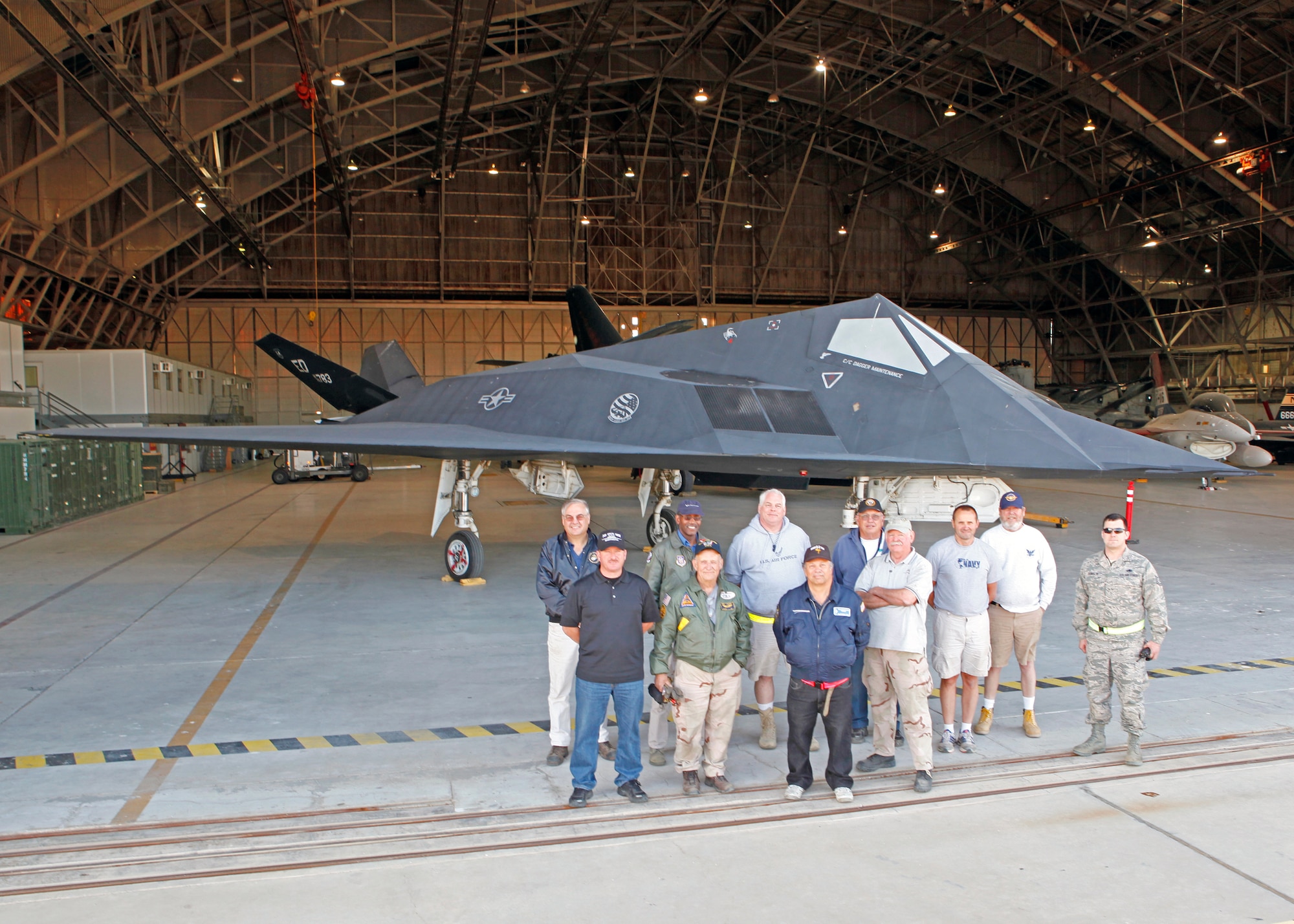 Members of the Air Force Flight Test Center Museum along with volunteers pose with one of the last F-117s left in the United States Air Force inventory June 8.  Tail number 783 was transported to Edwards from the AFFTC's Blackbird Air Park in Palmdale, Calif. The stealth aircraft will be refurbished and put on display in the future.  (U.S. Air Force photo by Jet Fabara)