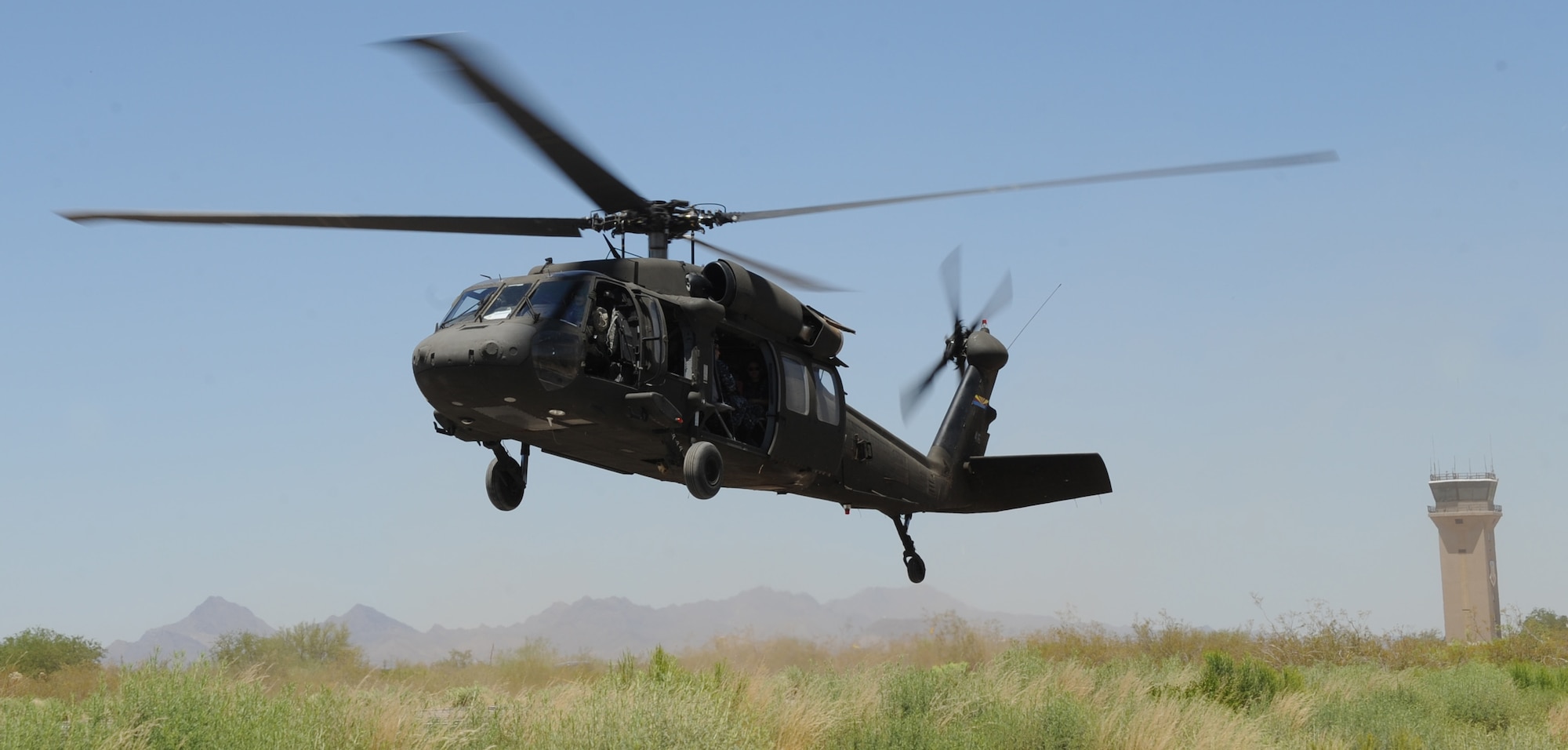 U.S. Army soldiers from the 2nd Battalion, 285th Aviation Regiment, Arizona Army National Guard prepare to land a UH-60 Black Hawk during helicopter pre-deployment training at Davis-Monthan Air Force Base, Ariz., June 7, 2012. The Black Hawk’s critical components and systems are armored and its airframe is designed to progressively crush on impact to protect the crew and passengers. (U.S. Air Force photo by Senior Airman Brittany Dowdle/released)