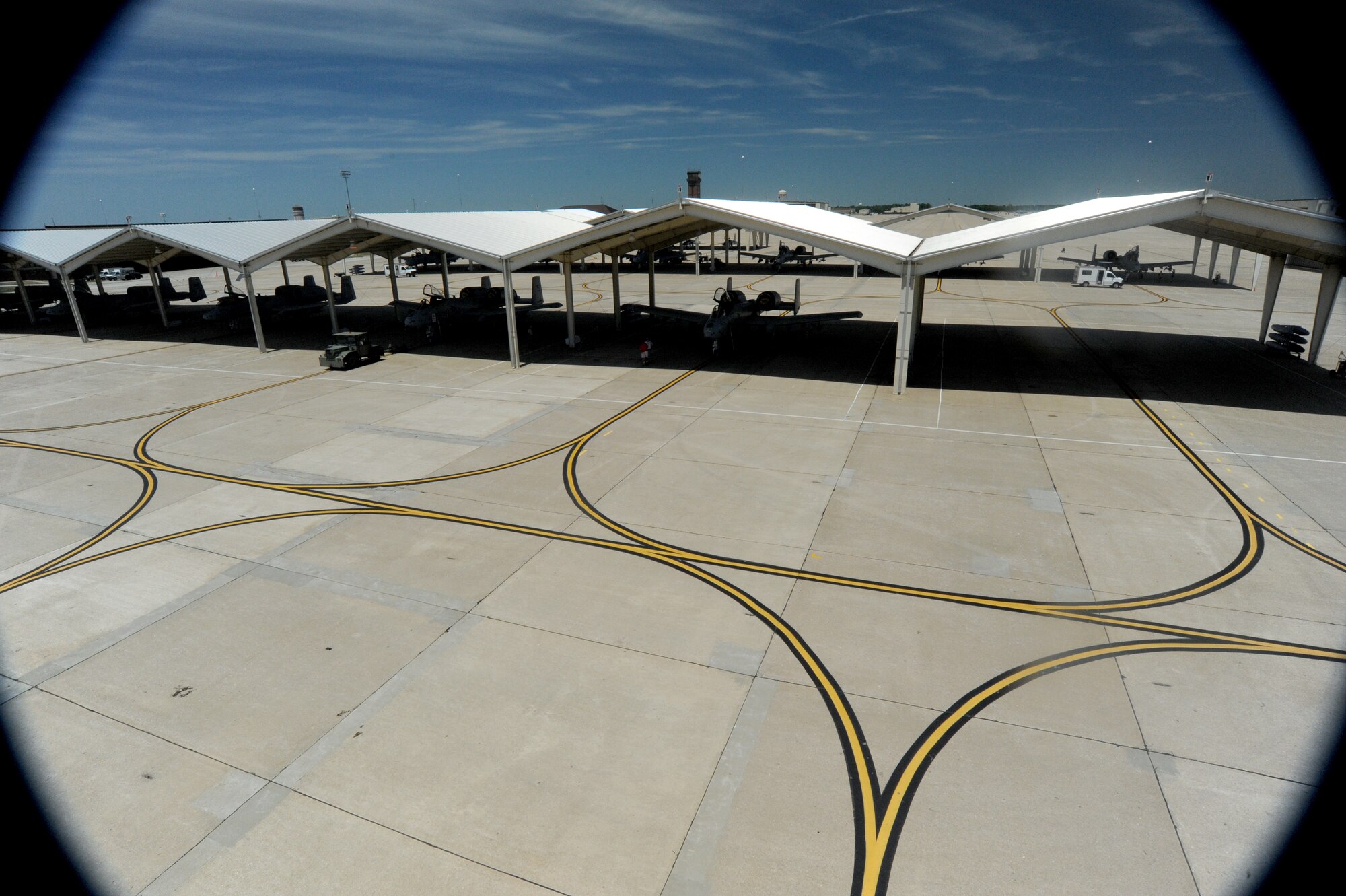 Civilian contractors perform upgrades to the A-10 Thunderbolt II sun shades June 12, 2012. The sun shades provide protection from the elements for the aircraft and the maintainers. The A-10s are assigned to the 442nd Fighter Wing, an Air Force Reserve unit at Whiteman Air Force Base, Mo. (U.S. Air Force photo/Staff Sgt. Danielle Johnston)