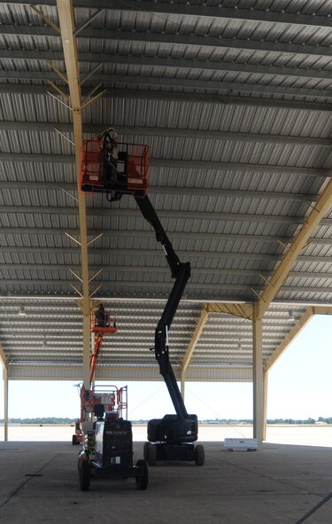 Civilian contractors perform upgrades to the A-10 Thunderbolt II sun shades June 12, 2012. The sun shades provide protection from the elements for the aircraft and the maintainers. The A-10s are assigned to the 442nd Fighter Wing, an Air Force Reserve unit at Whiteman Air Force Base, Mo. (U.S. Air Force photo/Staff Sgt. Danielle Johnston)