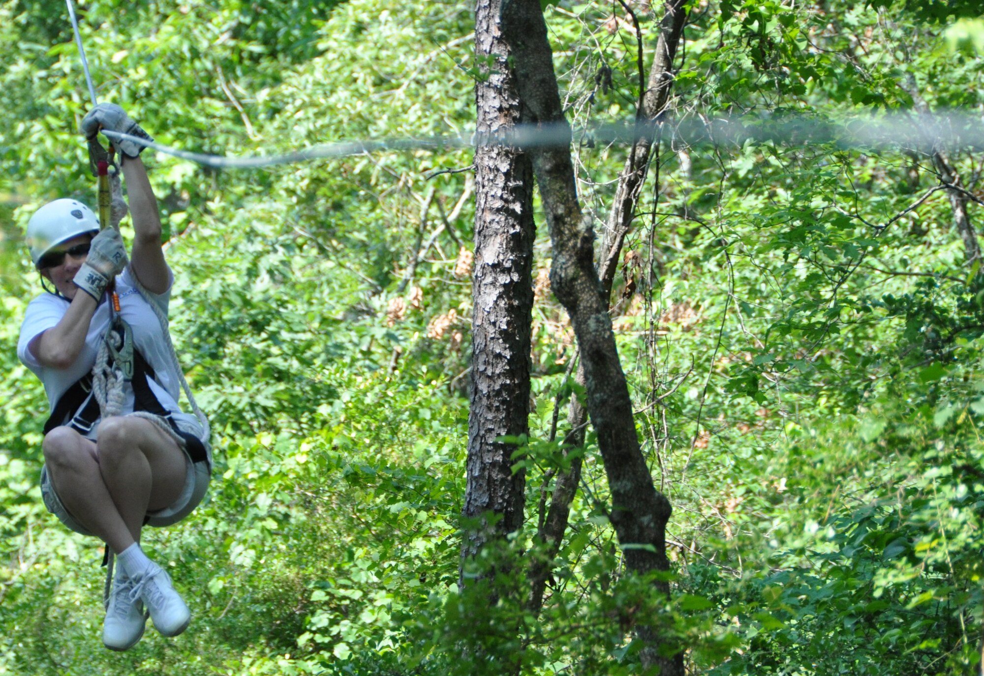 Missy Bozeman, 94th Airlift Wing Force Support Squadron event coordinator, enjoys the view as she speeds down the zip line during the Single Airman Initiative Zip Line Tour at historic Banning Mills, GA May 19. Bozeman, along with Fred Engel, 94th Airlift Wing services recreation director, has planned numerous events including Painting with a Twist and Cooking for two, as part of the Dobbin’s Single Airman Initiative. 