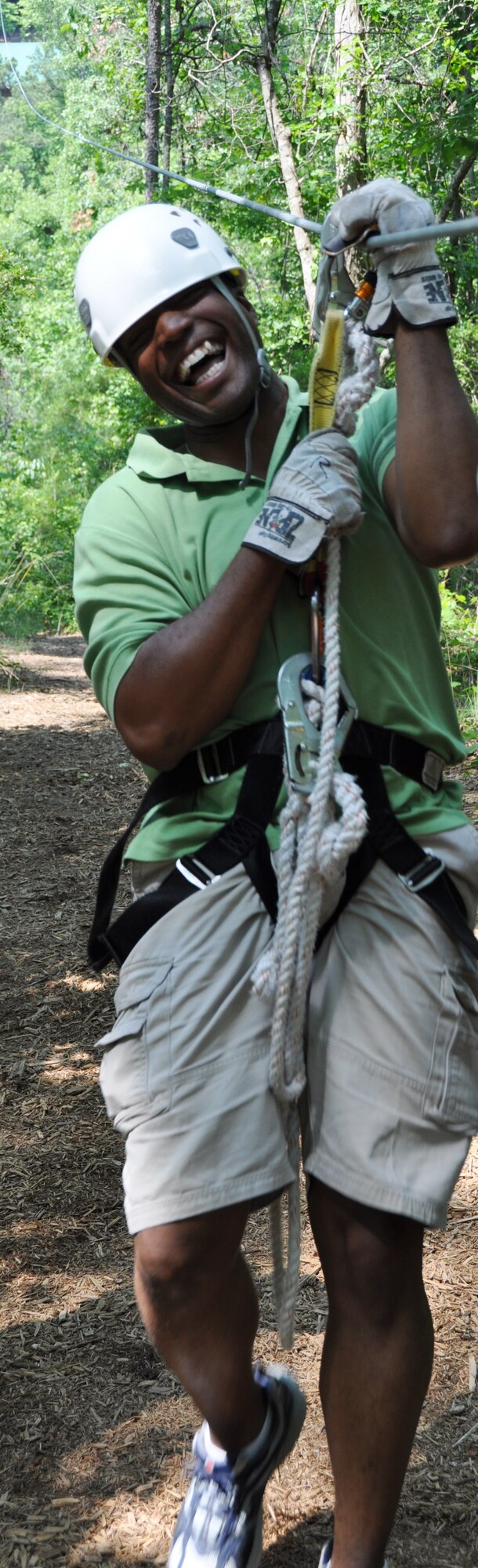 Senior Airman Keith Hood from the 94th Airlift Wing Civil Engineering Squadron, completes the 1500 foot-long zip line during the Single Airmen Initiative Zip Line Tour May 19 at historic Banning Mills, GA. Initiated here April 2012, the SAI began as an Air Force Headquarters project implemented to foster a strong culture and sense of community through fun, free activities for single Airmen. 