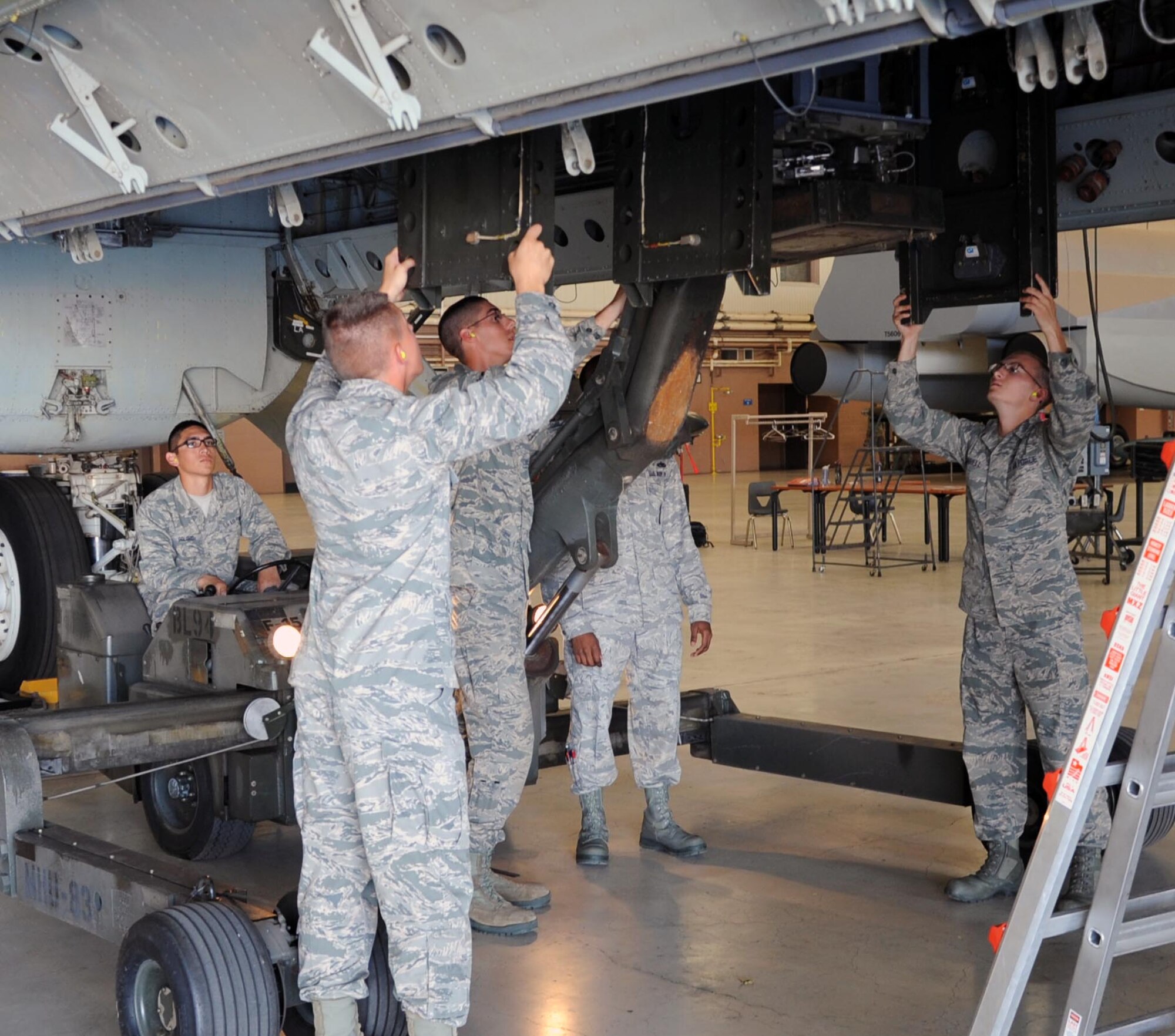 Airmen from the 363rd TRS train on loading munitions on a B-52.  The B-52 Armament Systems Apprentice course teaches airmen the fundamentals of B-52 armament systems.  (US Air Force Photo/Josh Wilson)