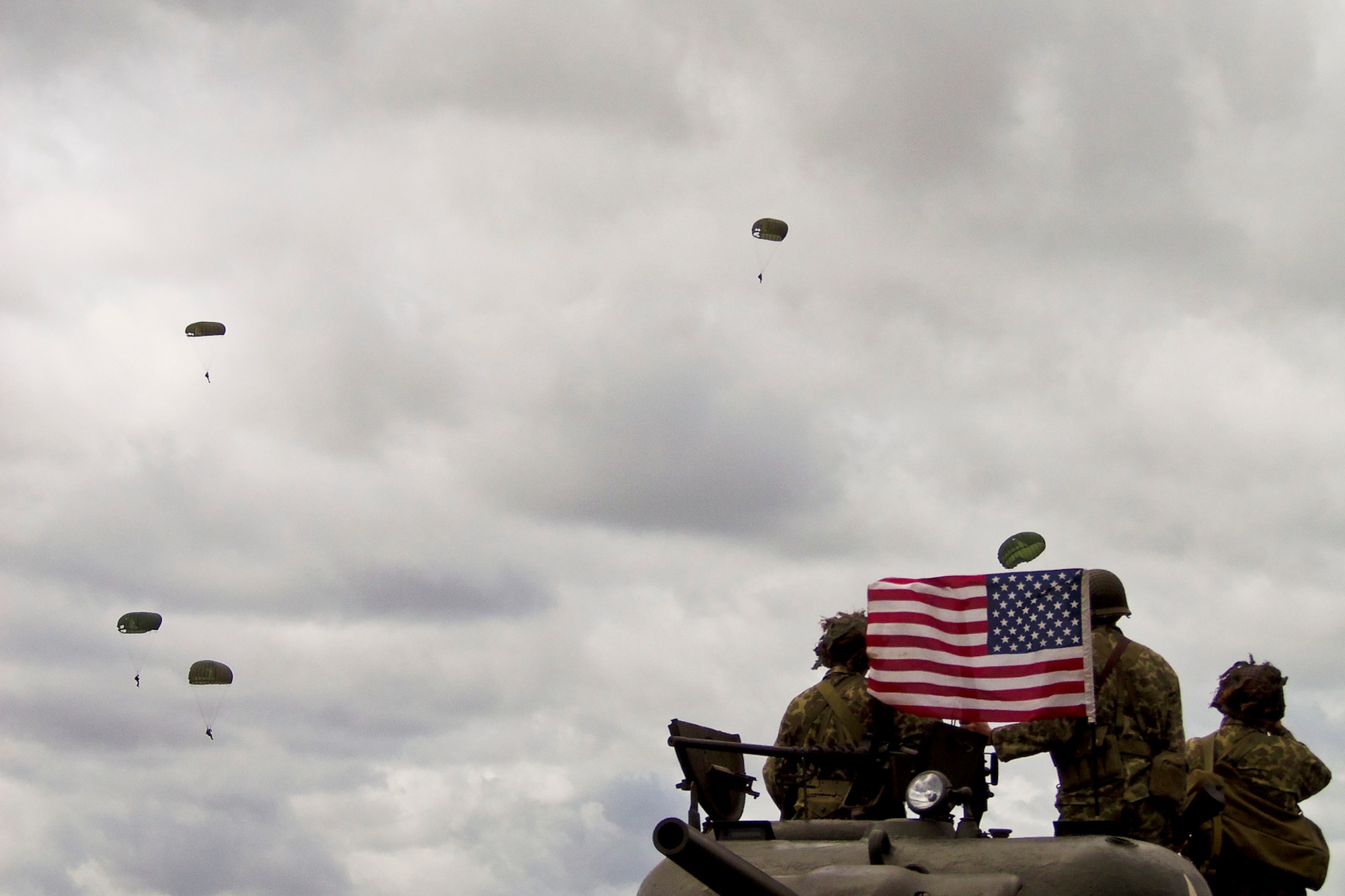 NORMANDY, France -- Paratroopers from the United States, Germany, France, Holland and the United Kingdom, re-enact the D-Day airborne operation here, June 3, 2012, to commemorate the heroic acts of the World War II paratroopers who made the jump 68 years ago. Youngstown Air Reserve Station Airmen participated in the commerative event. U.S. Air Force photo by Tech. Sgt. Ben Sewall