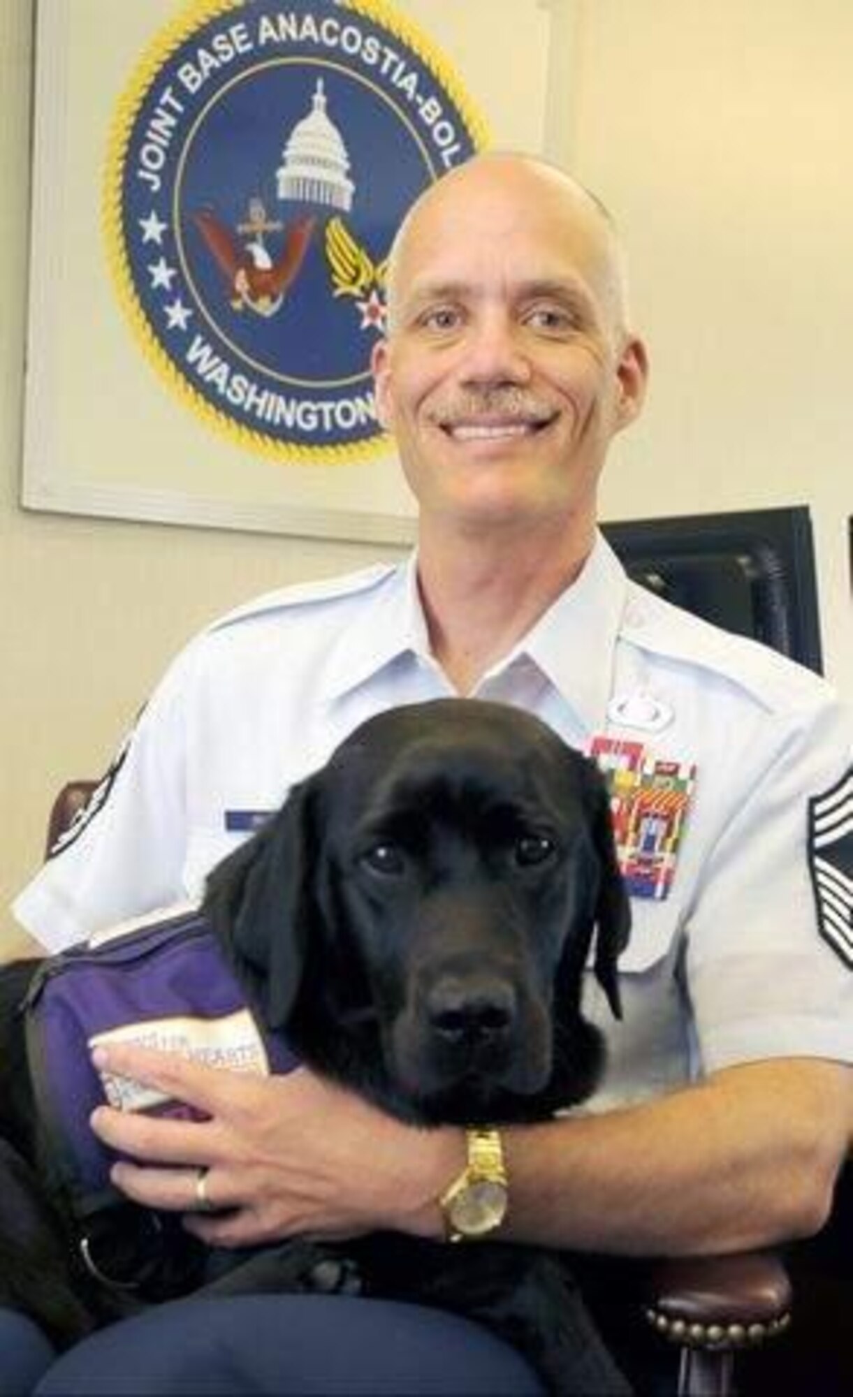 Chief Master Sgt. Richard Simonsen recently became the new senior enlisted leader at Joint Base Anacostia-Bolling, Md.  He is joined by his service dog, Yoko. (Air Force photo/ Senior Airman Steele C. G. Britton)