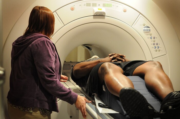 Magnetic Resonance Imaging Technologist Julie Walker explains the procedure to John L. Jackson ensuring he is ready for an exam of his cervical spine, the throat and neck area. The MRI technicians receive more than 70 requests for an MRI on a weekly basis. (U.S. Navy photo/Petty Officer 1st Class Jennifer Hudson)