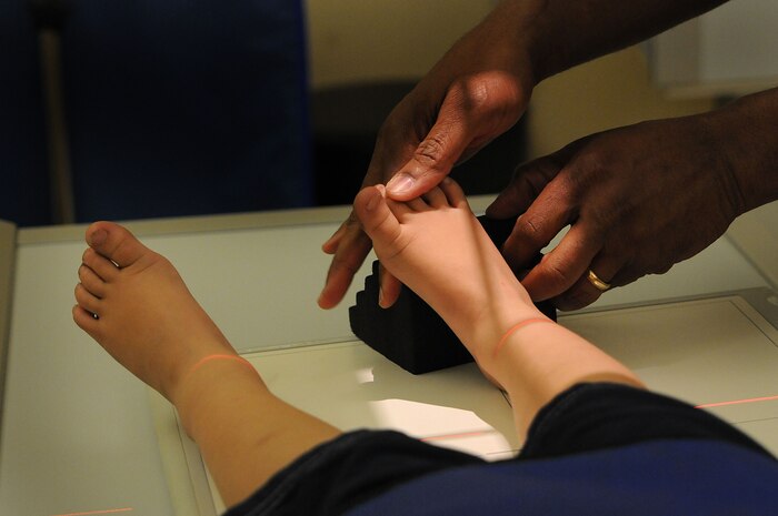 X-ray technician Orville Clarke places a sponge molding against three-year-old William Gordan’s right foot during an appointment for an X-Ray. Rachel Gordan, William’s mother, noticed swelling on her son’s ankle and brought him in to see if he had any breaks or fractures. Gordan is the wife of Petty Officer 1st Class William Gordan, a hospital corpsman assigned to Naval Operational Support Center Charleston. (U.S. Navy photo/Petty Officer 1st Class Jennifer Hudson)