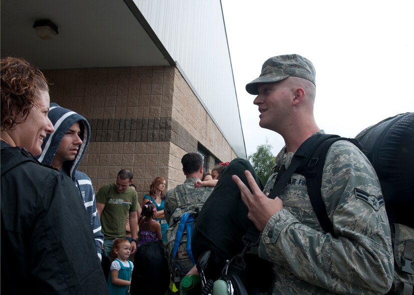 U.S. Air Force Airman 1st Class Chad Burns, 723d Aircraft Maintenance Squadron, greets friends after returning home from deployment to Afghanistan June 9, 2012, at Moody Air Force Base, Ga. Over a span of three days, family and friends welcomed home more than 60 returning Airmen from the 723d AMXS and 71st Rescue Squadron. (U.S. Air Force photo by Senior Airman Eileen Meier/Released) 