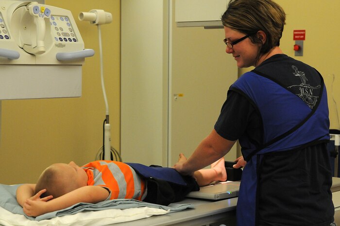 Military spouse Rachel Gordan comforts her son, three-year-old William Gordan, as she holds her son’s right ankle in place for X-rays.  Noticing swelling on the right ankle, Gordan brought him in to see if he had any breaks or fractures. Gordan is the wife of Petty Officer 1st Class William Gordan, a hospital corpsman assigned to Naval Operational Support Center Charleston. (U.S. Navy photo/Petty Officer 1st Class Jennifer Hudson)