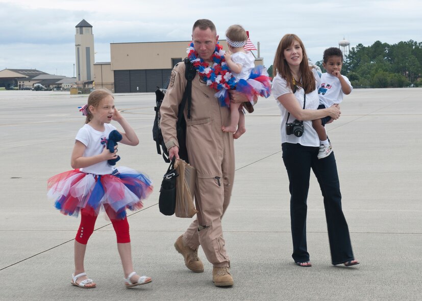 U.S. Air Force Lt. Col. Christopher Barber, 71st Rescue Squadron, walks with his family after returning home from deployment June 8, 2012, at Moody Air Force Base, Ga. Barber and Airmen from the 71st RQS and 723d Aircraft Maintenance Squadron spent four months in Camp Bastion, Afghanistan, in support of Operation Enduring Freedom. (U.S. Air Force photo by Senior Airman Eileen Meier/Released) 