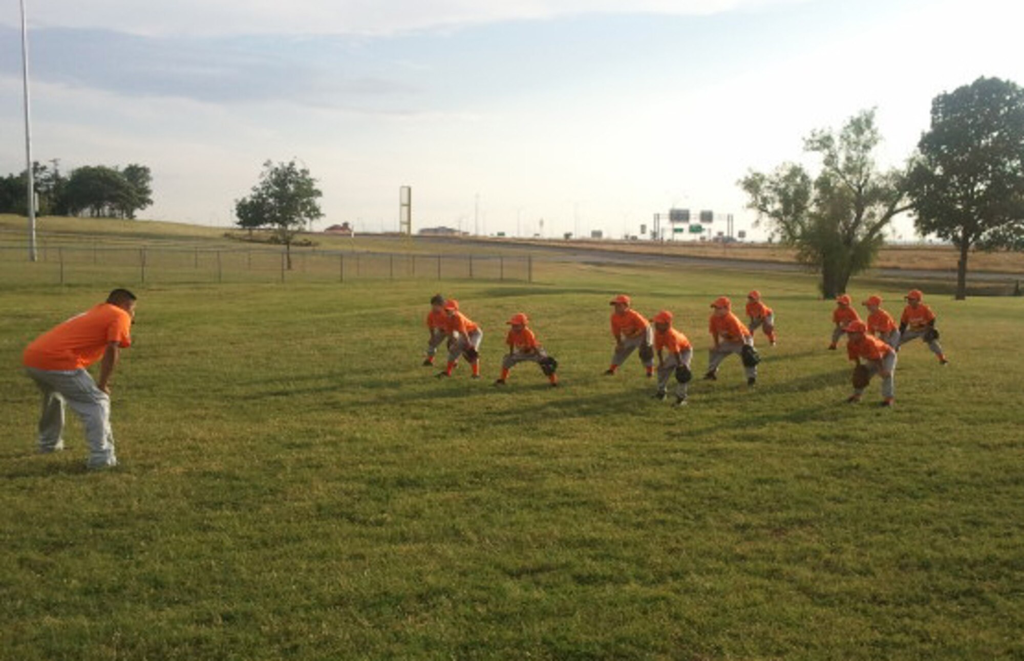 Master Sgt. Jose Guajardo, 301st Fighter Wing combat readiness evaluator, teaches his Lake Worth, Texas T-ball team, the Astros the importance of the ready position to defense Tuesday, May 8, 2012. (Courtesy photo)