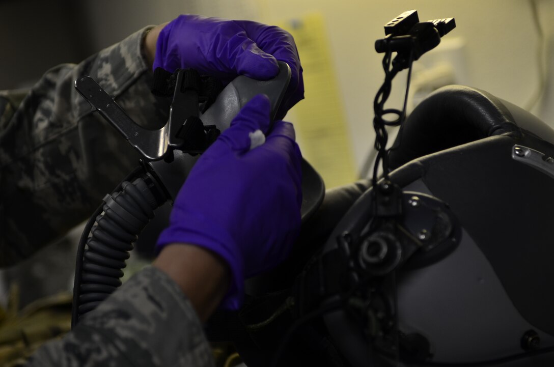 Staff Sgt. Christina Andrews, an aircrew equipment specialist assigned to the 129th Rescue Squadron, inspects a 55p helmet June 9, 2012 at Moffett Federal Airfield, Calif.  The 55p helmet is used by the 129th Rescue Wing's MC-130P Combat Shadow aircraft crews. (Air National Guard photo by Airman 1st Class John Pharr)