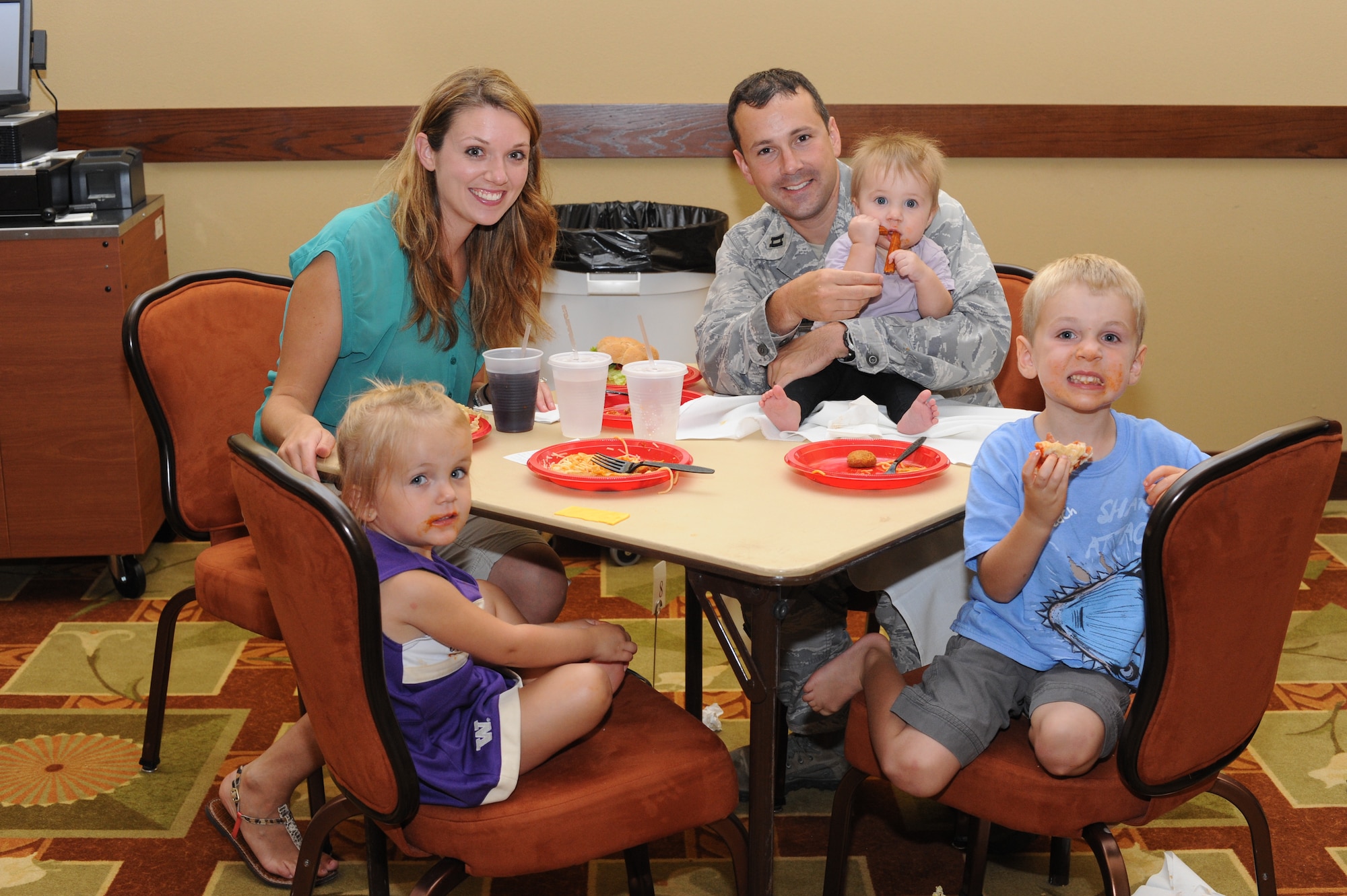 Capt. Kristina Sawtelle, Air Force Special Operations Command, left, and Capt. Jonathan Sawtelle, AFSOC, right, pose with their children, Ian, 4, Esmé, 2, and Zoe, nine months old, during the Family Night Out event at the Soundside Club at Hurlburt Field, Fla., June 9, 2012. Families at the event were served hot dogs, hamburgers, macaroni and cheese, spaghetti and sweet potato fries. (U.S. Air Force photo / Senior Airman Joe McFadden)(RELEASED)