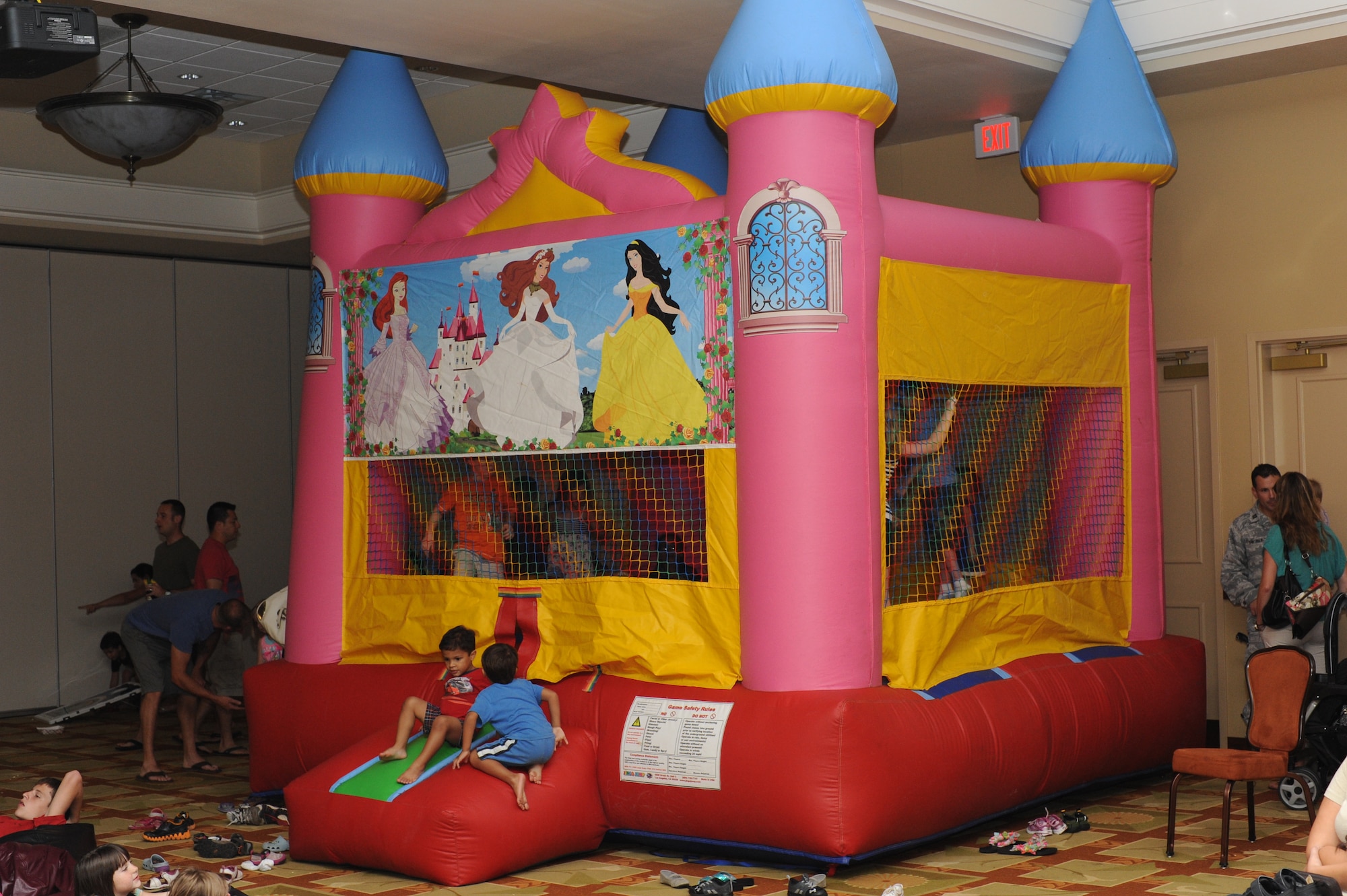 Children play in a large bounce castle during the Family Night Out event at the Soundside Club at Hurlburt Field, Fla., June 9, 2012. Children also had a chance to watch movies on two large screens and eat burgers and hot dogs at the event. (U.S. Air Force photo / Senior Airman Joe McFadden)(RELEASED)