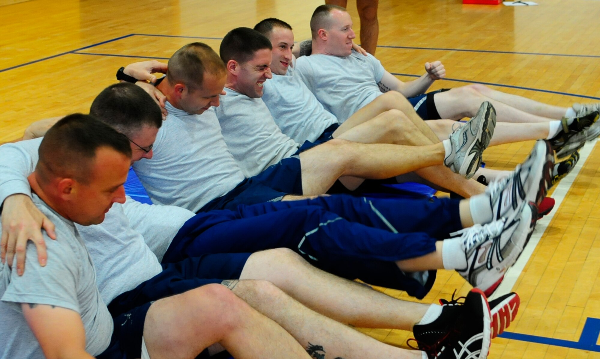 Students from the Resiliency Trainer Assistance course test their own resiliency and strength as they perform group physical training here, June 8. The RTA course taught students the core competencies that contribute to resilience:  self-awareness, self-regulation, optimism, mental agility, strengths of character and connection.  (U.S. Air Force photo/Airman 1st Class Hailey Haux)