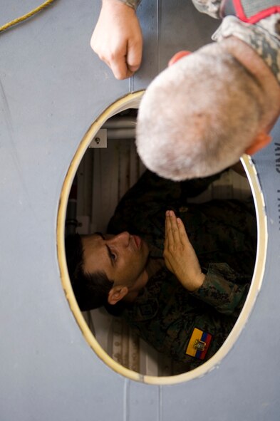 Ecuadorian air force Maj. Celio Puga talks to U.S. Air Force Master Sgt. Wilber Fryer, 317th Maintenance Squadron, about the C-130J’s dry dock June 4, 2012, while inside of one at Dyess Air Force Base, Texas. Puga has been stationed at Dyess for more than a year as part of a program that allows foreign servicemembers the opportunity to learn from the U.S. Air Force and vice verse. (U.S. Air Force photo by Airman 1st Class Damon Kasberg /Released)