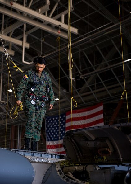 Ecuadorian air force Maj. Celio Puga stands on top of a C-130J’s wing during an inspection June 4, 2012, at Dyess Air Force Base, Texas. Puga has been stationed at Dyess for more than a year as part of a program that allows foreign servicemembers the opportunity to learn from the U.S. Air Force and vice verse. (U.S. Air Force photo by Airman 1st Class Damon Kasberg /Released)