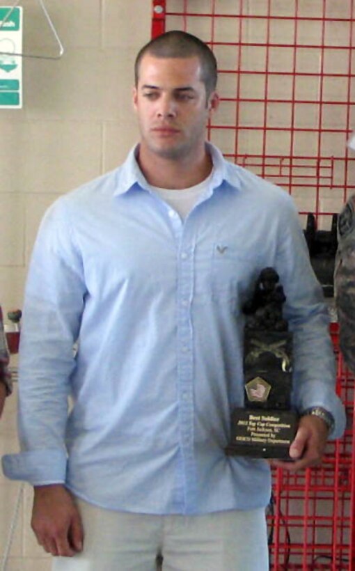 U.S. Army Spec. Brian Williamson, 221st Military Police Detachment, is awarded as winner of the U.S. Army’s 2012 TOP COP Competition June 5. Police officers competed in two-man teams in six different scenarios many law enforcement officers encounter in their careers. (Courtesy photo)
