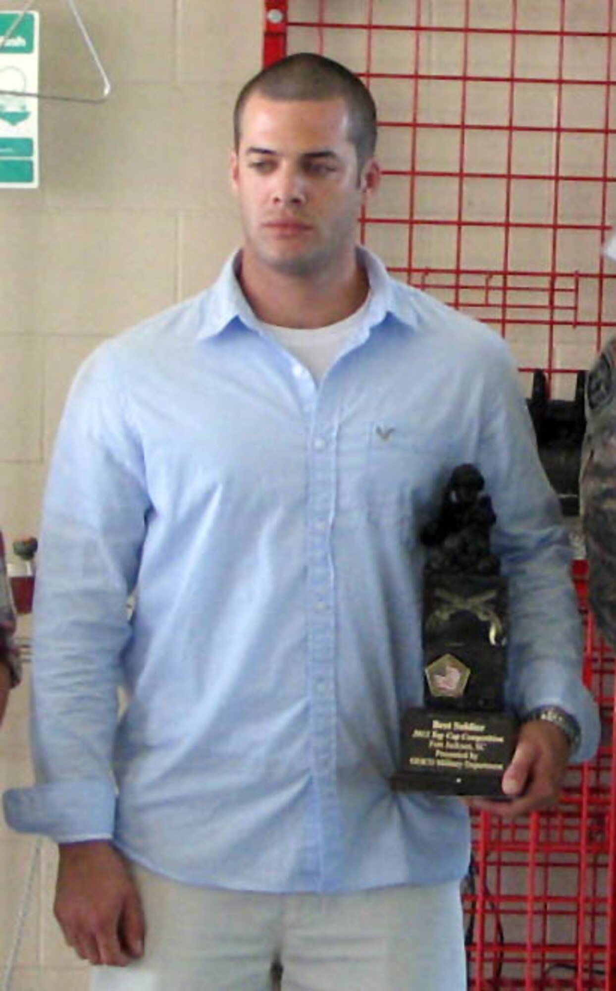 U.S. Army Spec. Brian Williamson, 221st Military Police Detachment, is awarded as winner of the U.S. Army’s 2012 TOP COP Competition June 5. Police officers competed in two-man teams in six different scenarios many law enforcement officers encounter in their careers. (Courtesy photo)