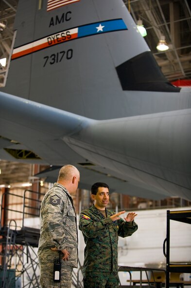 U.S. Air Force Master Sgt. Wilber Fryer, 317th Maintenance Squadron, talks with Ecuadorian air force Maj. Celio Puga about the C-130J June 4, 2012, at Dyess Air Force Base, Texas. Puga has been stationed at Dyess for more than a year as part of a program that allows foreign servicemembers the opportunity to learn from the U.S. Air Force and vice verse.  (U.S. Air Force photo by Airman 1st Class Damon Kasberg /Released)