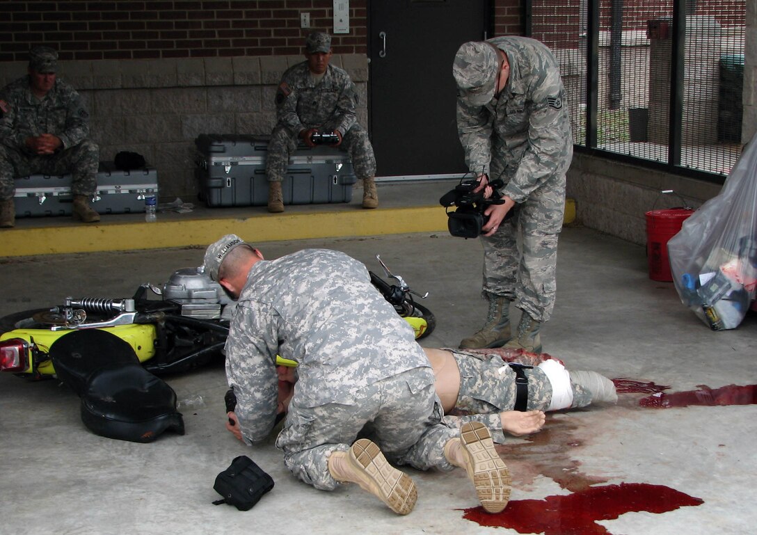 U.S. Army Spec. Brian Williamson, foreground, 221st Military Police Detachment, treats a “motorcycle accident casualty” June 3, during the 3rd Annual Private 1st Class Boyd Jr. Top Cop Competition at Ft. Jackson, S.C. Williamson went on to win the Soldier’s division of the competition. (Courtesy photo)