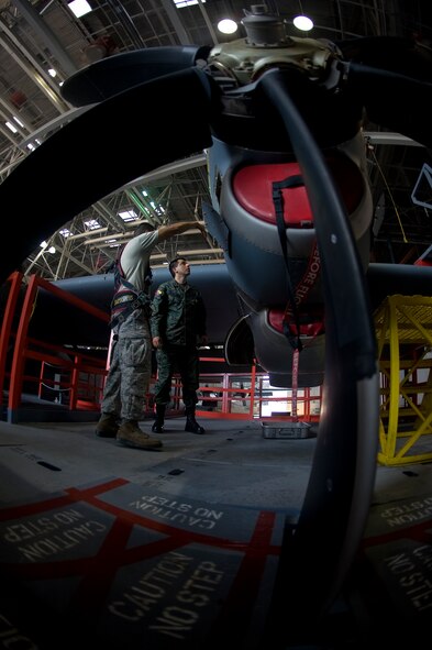 U.S. Air Force Staff Sgt. Immanuel Inadomi, 317th Maintenance Squadron, shows Ecuadorian air force Maj. Celio Puga a C-130J’s engine June 4, 2012, during an inspection at Dyess Air Force Base, Texas.  Puga has been stationed at Dyess for more than a year as part of a program that allows foreign servicemembers the opportunity to learn from the U.S. Air Force and vice verse. (U.S. Air Force photo by Airman 1st Class Damon Kasberg/Released)