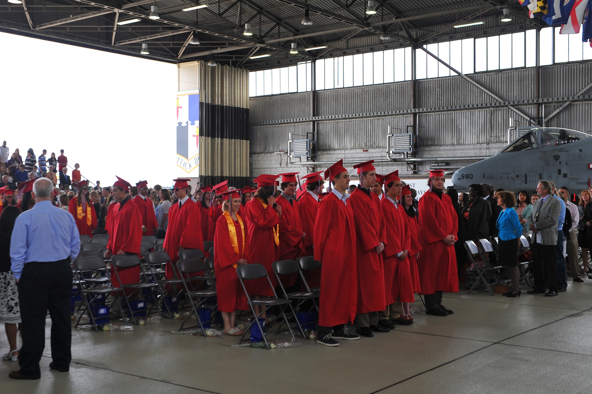 SPANGDAHLEM AIR BASE, Germany – Students of the Bitburg High School graduating class of 2012 file into their seats during the graduation ceremony inside Hangar 1 here June 9. The class of 2012 consisted of 54 students. More than 300 family members and guests attended the ceremony to celebrate the completion of their high school education. (U.S. Air Force photo by Airman 1st Class Dillon Davis/Released)