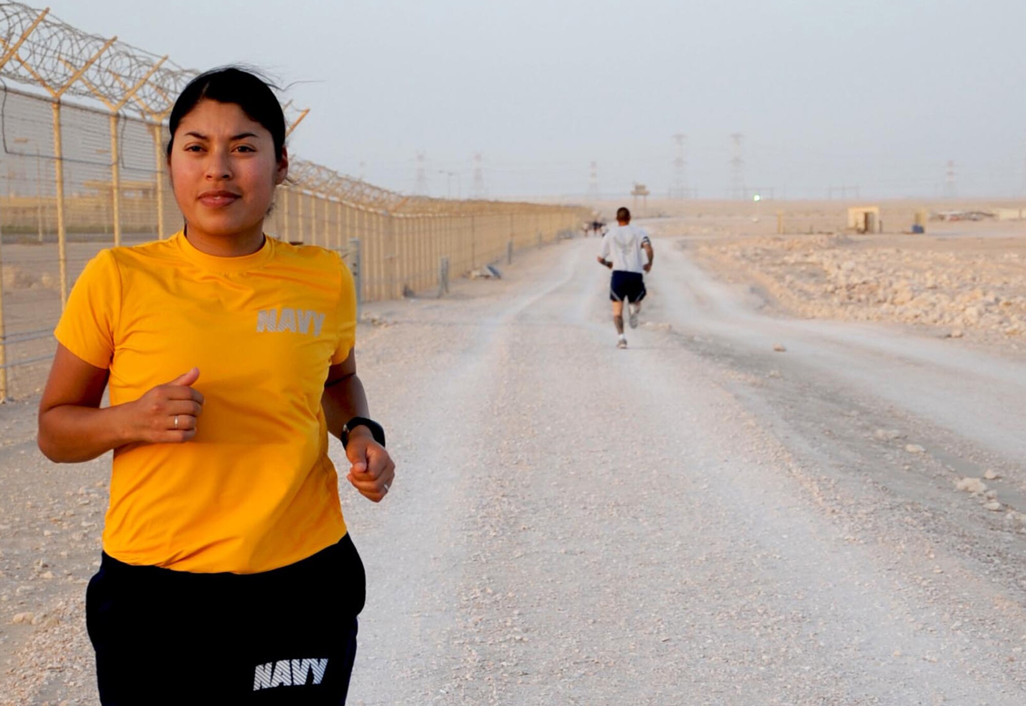 U.S. Navy Petty Officer Sol Benavides, U.S. Air Forces Central assistant to the senior defense officer, runs along the 2.5-mile track. Benavides recently challenged herself to run 30 miles on her 30th birthday. (U.S. Air Force photo by Master Sgt. Ryan Kruse/Released)
