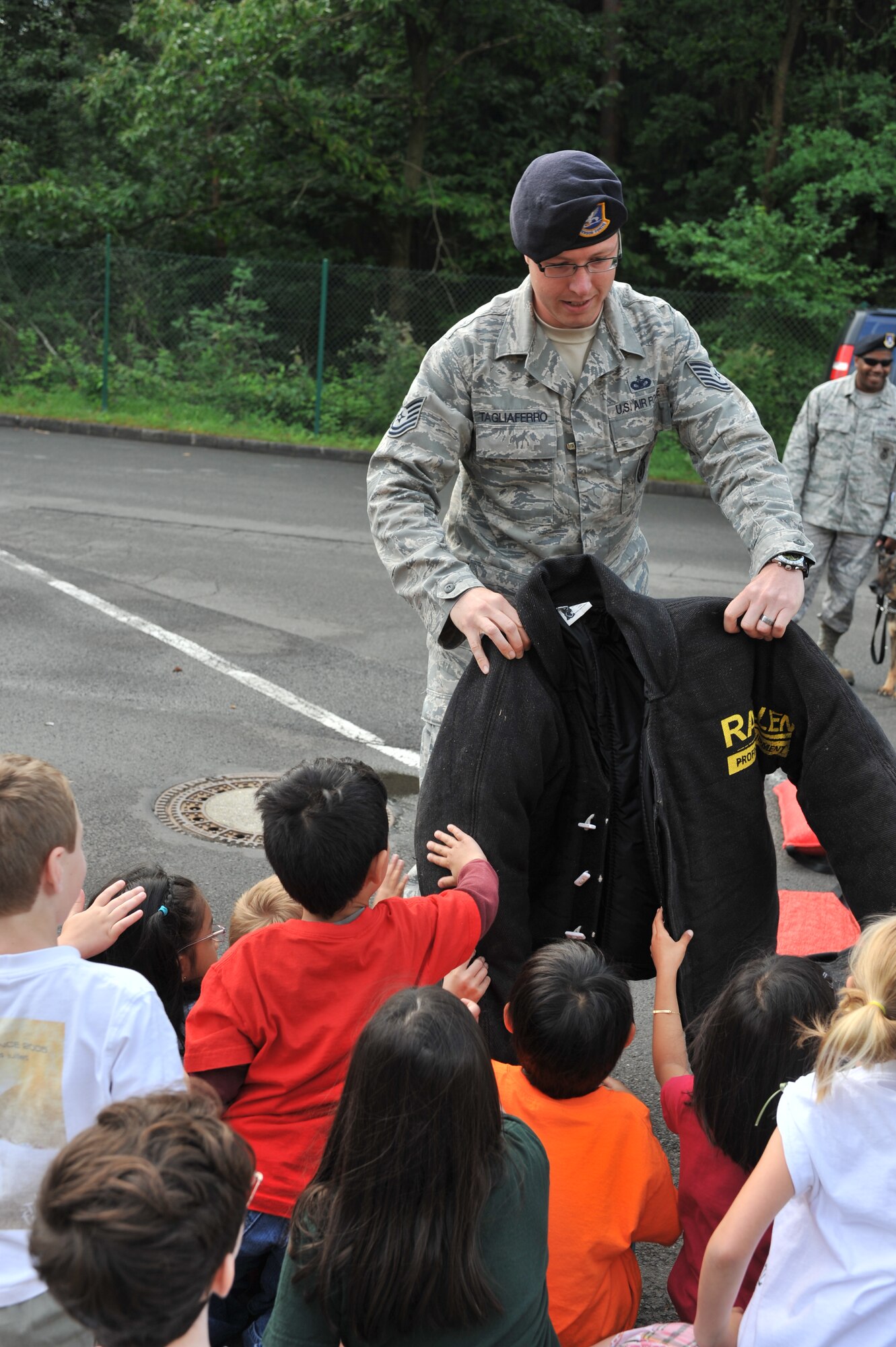 Tech. Sgt. David Tagliaferro, 86th Security Forces Squadron Military Working Dog trainer, displays a variety of protective equipment to 1st graders in elementary school on Ramstein Air Base, Germany. 12 June, 2012. The Ramstein Bug Out is an annual event held prior to summer break that allows students the chance to end school in a fun way.  (U.S. Air Force photo/Senior Airman Caitlin O’Neil-McKeown)