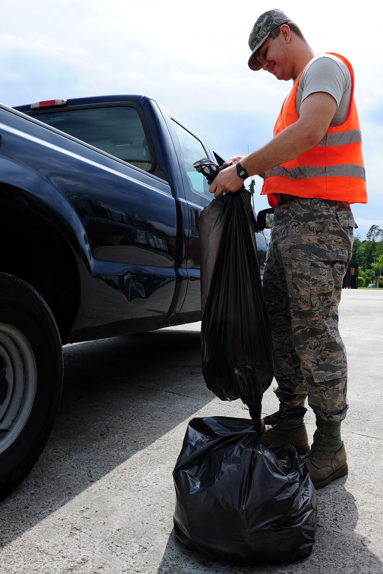 Airman 1st Class Dallas Arceneaux, 1st Combat Communications Squadron Tactical Network Operations Technician, ties trash bags while assigned to Facility Excellence on Ramstein Air Base, Germany, June 7, 2012. Participants appointed to Facility Excellence maintain the base's high quality of excellence for all distinguished visitors and those visiting Ramstein. (U.S. Air Force photo/Airman 1st Class Holly Cook)