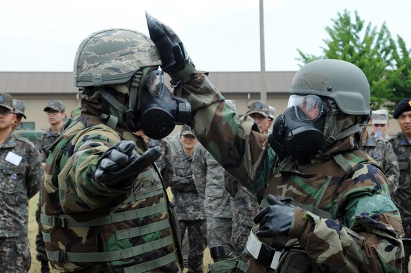 Staff Sgt. Ashley Bartlett, right, 8th Civil Engineer Squadron, decontaminates Master Sgt. Jeffrey Randall, 8th CES, during a demonstration of a contamination control area for Republic of Korea Air Force members June 8, 2012, at Kunsan Air Base, Republic of Korea. Because U.S. and South Korean forces would work together during a chemical, biological, radiological or nuclear attack, being familiar with the other’s equipment and procedures is important. (U.S. Air Force photo/Senior Airman Brigitte N. Brantley)