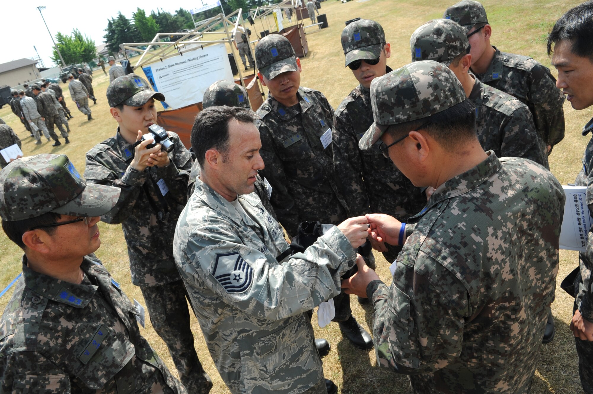 Master Sgt. Jeffrey Randall, 8th Civil Engineer Squadron emergency management flight superintendent, discusses the M-50 gas mask with Republic of Korea Air Force members from the 38th Fighter Group June 8, 2012, at Kunsan Air Base, Republic of Korea. Because U.S. and South Korean forces would work together during a chemical, biological, radiological or nuclear attack, being familiar with the other’s equipment and procedures is helpful. (U.S. Air Force photo/Senior Airman Brigitte N. Brantley)