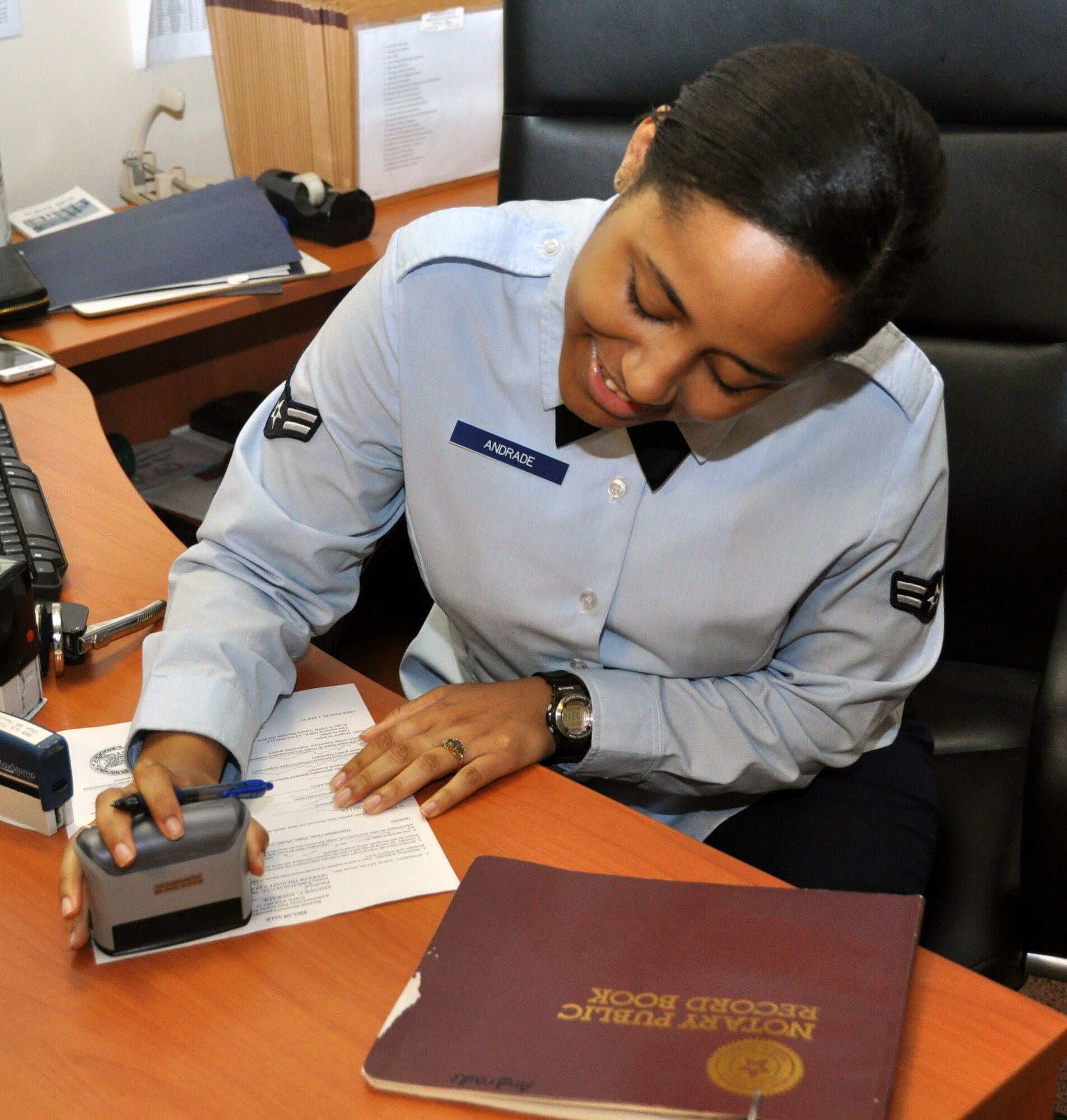 Airman 1st Class Adande Andrade, 51st Fighter Wing Judge Advocate's general law paralegal, notarizes a document for a client at Osan Air Base, Republic of Korea, June 11, 2012. Since Jan. 1, 2012, the legal office has consulted and prepared approximately 300 legal documents for clients. They also prepare more than 900 state and federal taxes for customers during tax season, saving service members more than $190,000 in tax preparation costs and over one million dollars in returns for their clients. (U.S. Air Force photo/Senior Airman Michael Battles)