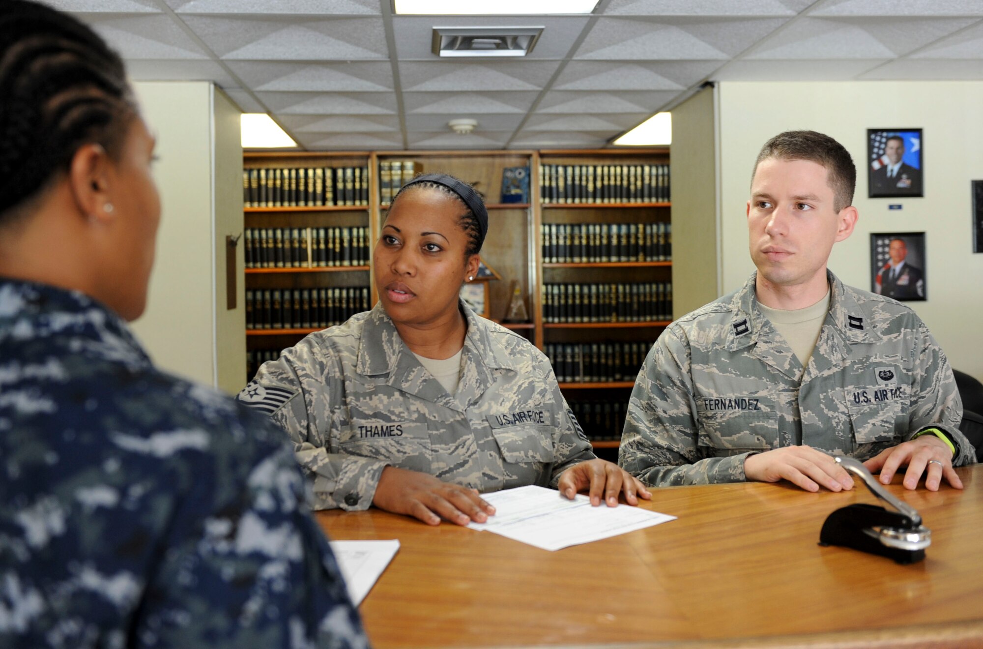 U.S. Air Force Tech. Sgt. Rosemarie Thomas, 18th Wing Legal Office NCO in charge of claims, and Capt. Rogelio Fernandez, 18th Wing Legal Office assistant staff judge advocate, answer a question from U.S. Navy Petty Officer 2nd Class Ashlley Tapia, a hospital corpsman stationed at Camp Lester, on Kadena Air Base, Japan, June 8, 2012. Last year, the legal office assisted 10,601 customers. Call 634-3300 to make an appointment for will drafting services, which are offered between 1-2 p.m. on Tuesdays. (U.S. Air Force photo/Airman 1st Class Brooke P. Beers)
