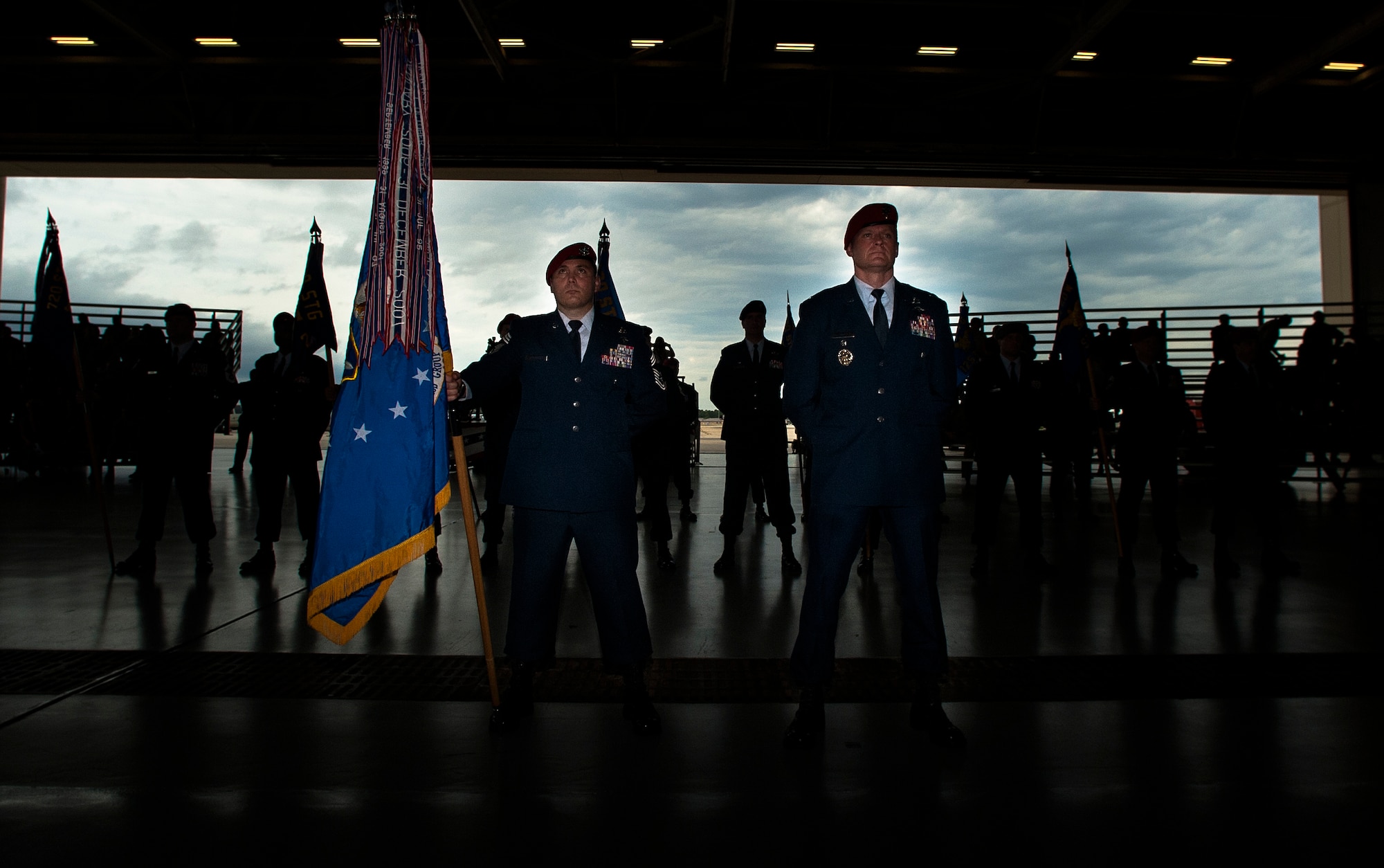 U.S. Air Force members from the 720th Special Tactics Group stand at parade rest during a change of command ceremony at Freedom Hangar on Hurlburt Field, Fla., June 12, 2012. The 720th STG welcomed Col. Kurt Buller as the commander and activated the 24th Special Operations Wing on Hurlburt Field. (U.S. Air Force photo/Airman 1st Class Christopher Williams)(Released)
