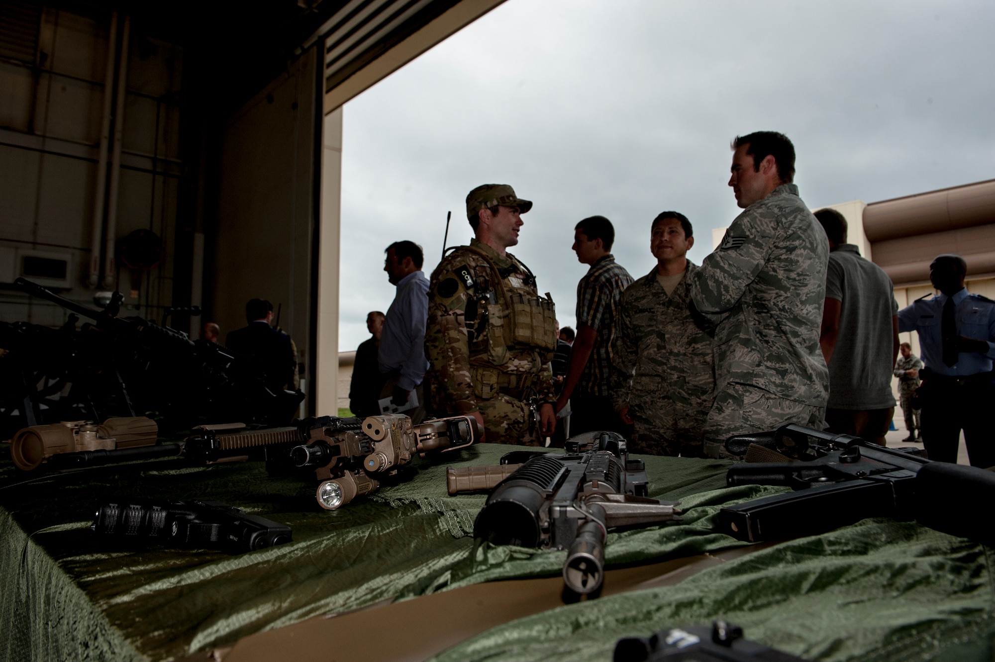 U.S. Air Force members discuss various weapons with a combat controller at Freedom Hangar on Hurlburt Field, Fla., June 12, 2012. The Air Force Special Operations Command hosted the 720th Special Tactics Group change of command and the 24th Special Operations Wing activation. (U.S. Air Force photo/Airman 1st Class Christopher Williams)(Released)

