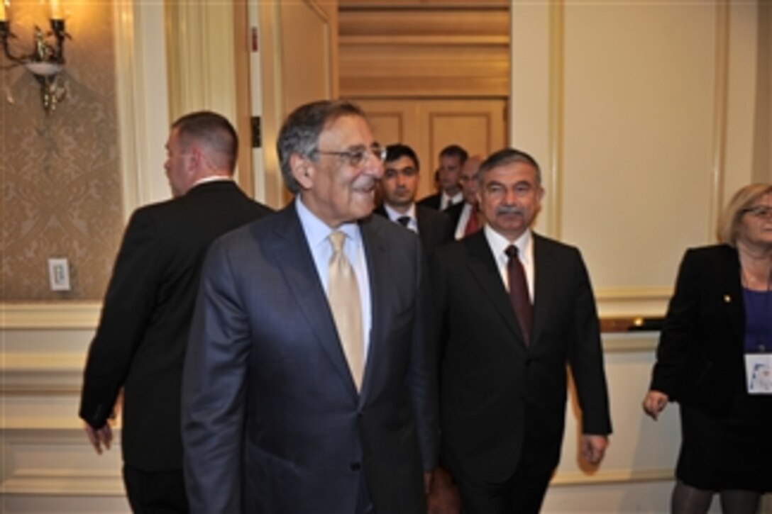 Secretary of Defense Leon E. Panetta is escorted by Turkish Minister of National Defense Ismet Yilmaz as he arrives to attend the 31st American Turkish Council Conference Dinner in Washington, D.C., on June 11, 2012.  