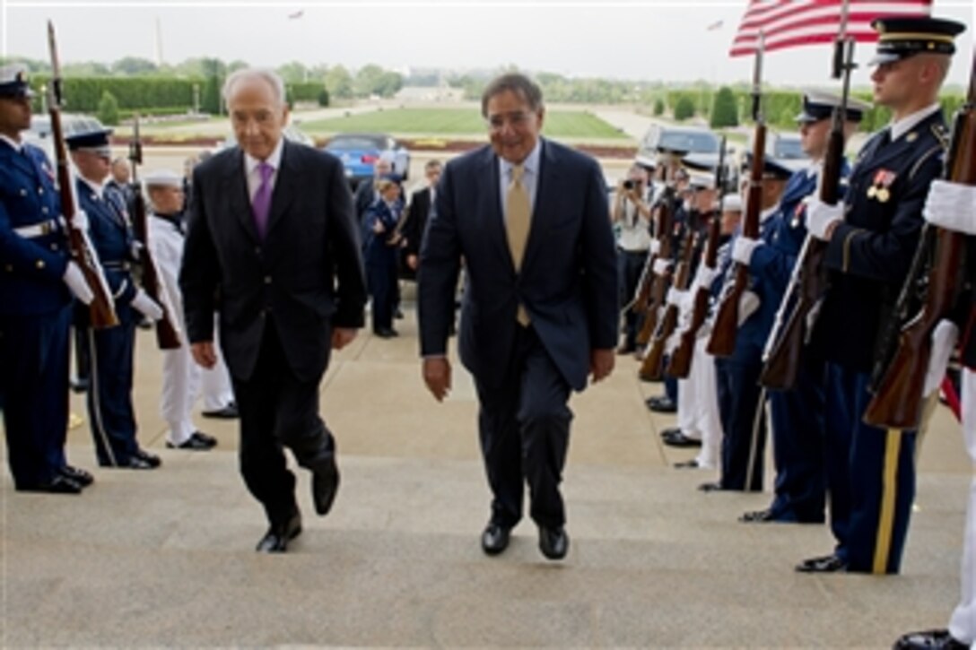 Secretary of Defense Leon E. Panetta escorts Israel's President Shimon Peres through an honor cordon and into the Pentagon on June 11, 2012.  Panetta, Peres, and their senior advisors will meet to discuss security issues and the strong relationship between the United States and Israel.  