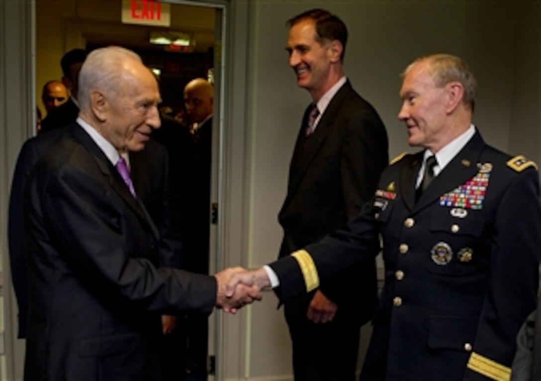 Israel's President Shimon Peres greets Chairman of the Joint Chiefs of Staff Gen. Martin E. Dempsey, U.S. Army, in the Pentagon on June 11, 2012.  Dempsey will join Secretary of Defense Leon E. Panetta and Peres to discuss security issues and the strong relationship between the United States and Israel.  