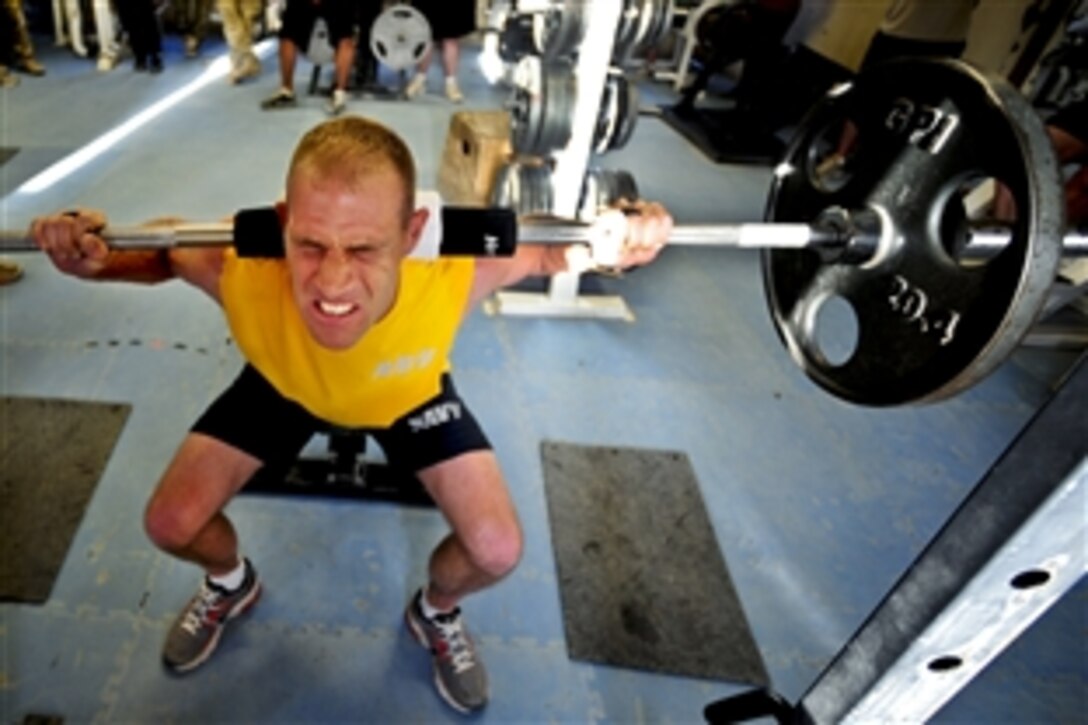 Members of Provincial Reconstruction Team Farah enjoy a friendly weight-lifting competition on Forward Operating Base Farah, Afghanistan, June 12, 2012. The competition includes five events and the individual who wins three of them takes away bragging rights.