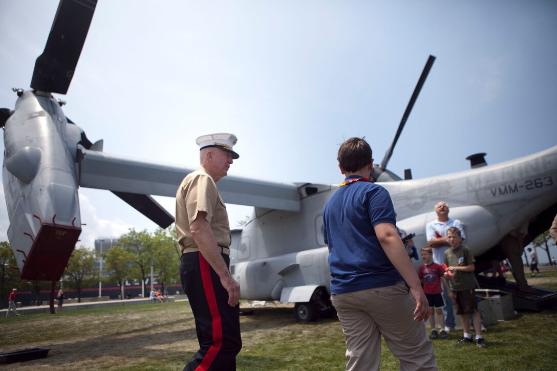 Lt. Gen. Steven A. Hummer, commander of Marine Forces Reserve and Marine Forces North, walks with Dominic Simone, a Cleveland native, toward an MV-22 Osprey parked at Voinovich Park here June 12. Voinovich Park is one of the sites of displays available for public during the Marine Week Cleveland. Along with the traveling Vietnam War Memorial Wall, Marine Corps vehicles, aircraft and equipment will be available for viewing at Public Square, Voinovich Park, Gateway Plaza and Rock and Roll Hall of Fame. Marine Week Cleveland celebrates community, country and the Corps. More than 750 Marines journeyed to Cleveland for the event, which runs through June 17. Ohio has more than 9,000 active and reserve Marines, making it one of the top-five producers of Marines.
