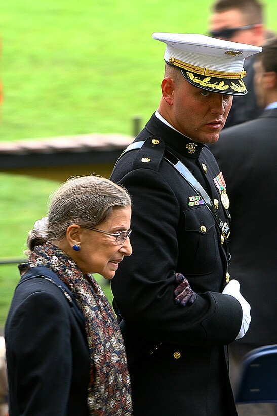 Maj. Thomas Shields, Headquarters & Service Company commanding officer, escorts Ruth Bader Ginsburg, Associate Justice of the U.S. Supreme Court, prior to the commencement of a Tuesday Sunset Parade at the Marine Corps War Memorial in Arlington, Va., June 12. Bader Ginsburg was the guest of honor of the parade.