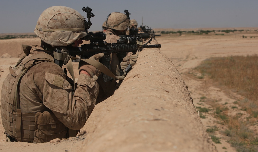 Marines with Alpha Company, 1st Battalion, 8th Marines, Regimental Combat Team 6, search for enemy fighters from their patrol base during Operation Trap House in Deh Mushek village, Afghanistan, May 26, 2012.