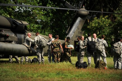 Members of Joint Task Force-Bravo and El Salvador’s armed forces unload medical supplies, food, and water from a UH-60 Blackhawk helicopter during a two-day joint Medical Readiness Training Exercise. JTF-Bravo’s 1-228 Aviation Regiment works together with the Army Forces Battalion  and Medical Element to consistently provide transportation for MEDRETEs. (U.S. Air Force photo/1st Lt. Christopher Diaz)