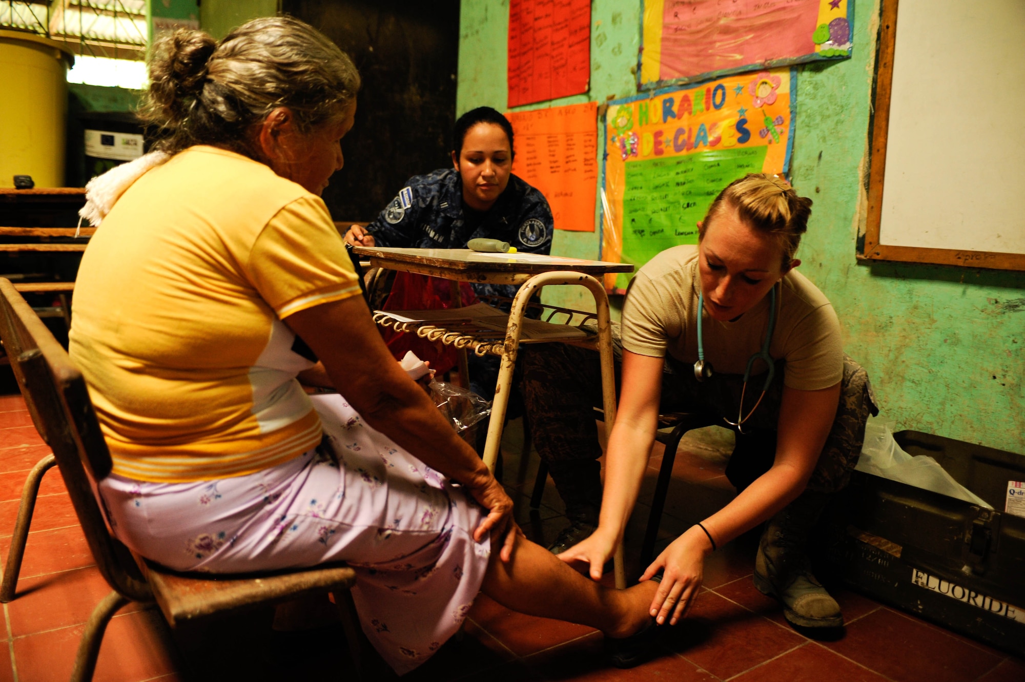 Air Force 1st Lt. Jess Looft, Joint Task Force-Bravo Medical Element nurse, checks a patient’s leg for swelling during a two-day joint Medical Readiness Training Exercise in partner with El Salvador’s Ministry of Health and military. The team provided care to 776 local patients in the municipalities of El Castano and Rancho San Marcos, El Salvador. (U.S. Air Force photo/1st Lt. Christopher Diaz)