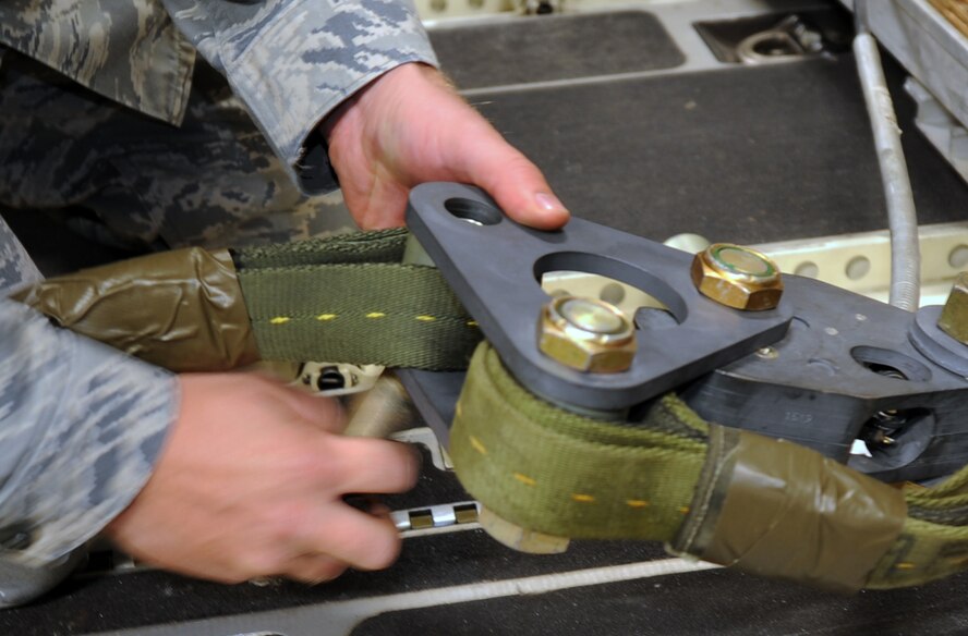 Staff Sgt. Brett Radziewicz, a loadmaster from the 535th Operations Support Squadron at Joint Base Pearl Harbor-Hickam, Hawaii, secures an extraction line to the extraction force transfer coupling on a 3,200-pound heavy aerial delivery platform aboard a JBPHH C-17 Globemaster III aircraft from the 535th Airlift Squadron June 13 as part of the RED FLAG-Alaska military exercise. RED FLAG-Alaska is one of the largest international air-combat employment exercises in the world and is designed to test the specific capabilities of the military units that take part in the exercise and increase their chance of survival during actual combat. (U.S. Air Force photo by Capt. Ben Sakrisson)