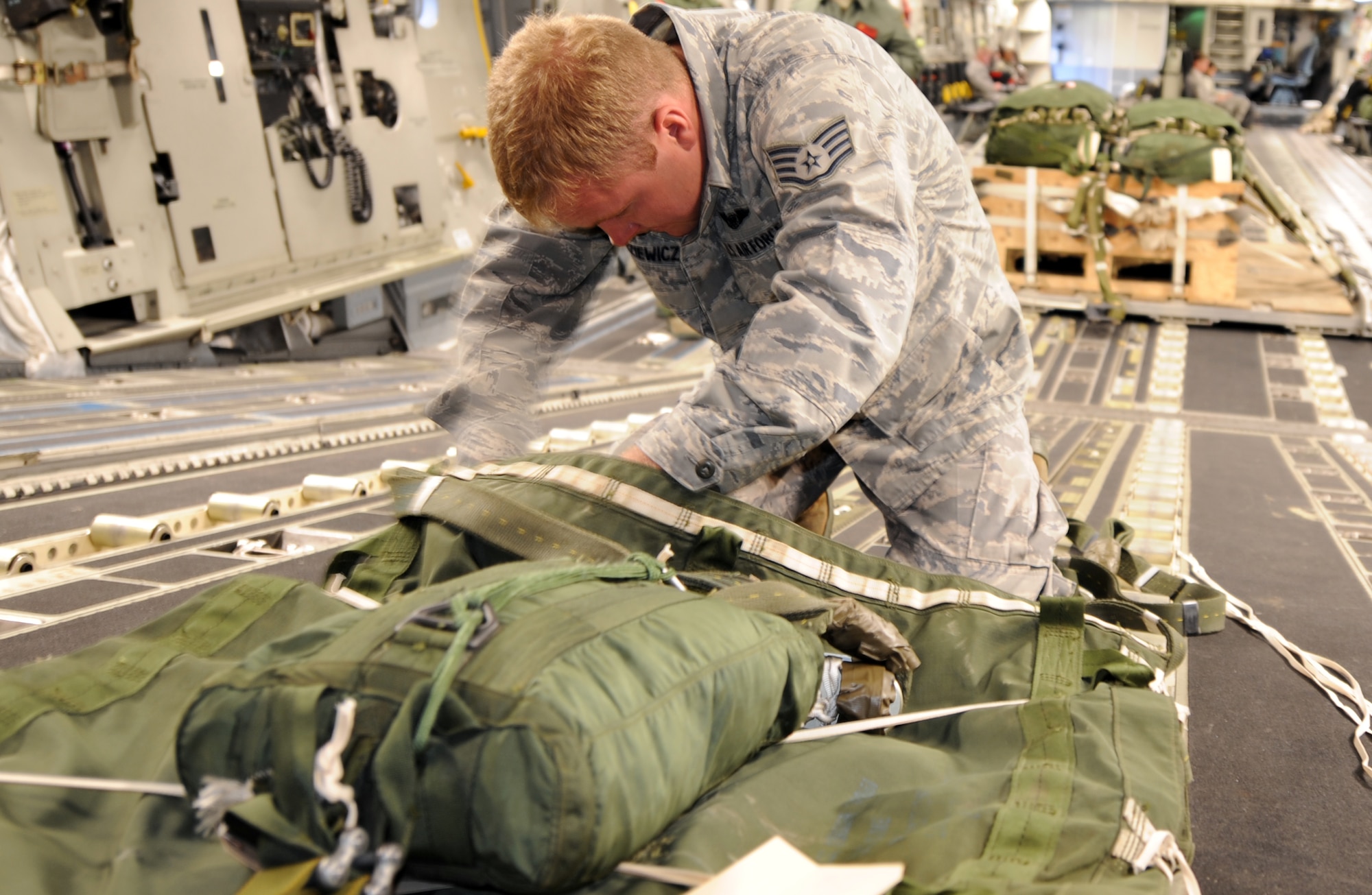 Staff Sgt. Brett Radziewicz, a loadmaster from the 15th Operations Support Squadron at Joint Base Pearl Harbor-Hickam, Hawaii, secures a single extraction line bag connected to a 3,200-pound heavy aerial delivery platform aboard a JBPHH C-17 Globemaster III aircraft from the 535th Airlift Squadron June 13 as part of the RED FLAG-Alaska military exercise. RED FLAG-Alaska is one of the largest international air-combat employment exercises in the world and is designed to test the specific capabilities of the military units that take part in the exercise and increase their chance of survival during actual combat. (U.S. Air Force photo by Capt. Ben Sakrisson)